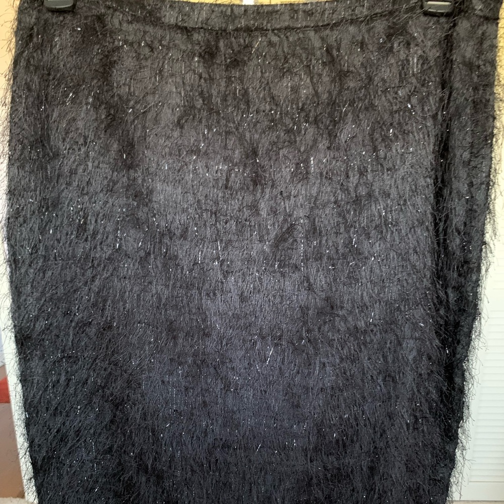 It’s soft beautiful black skirt with hints of silver and mohair